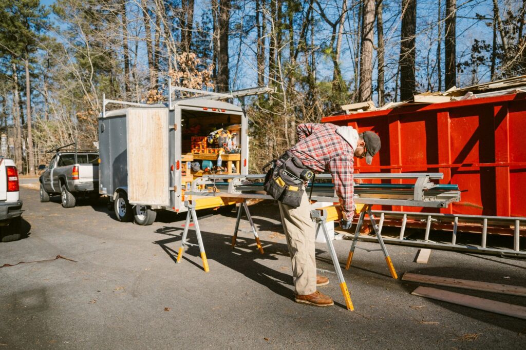 Construction worker setting up work bench to bend sheet metal